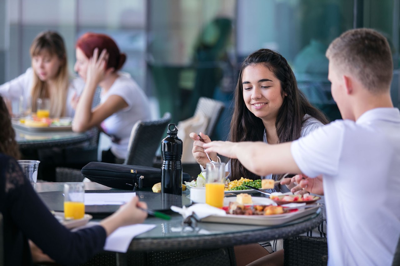 ABU DHABI, UNITED ARAB EMIRATES, November 08, 2015:Students socialize as they eat their lunch at one of two dining halls on NYU Abu Dhabi campus on Saadiyat Island.  (Photo / Silvia Razgova - Philip Cheung)