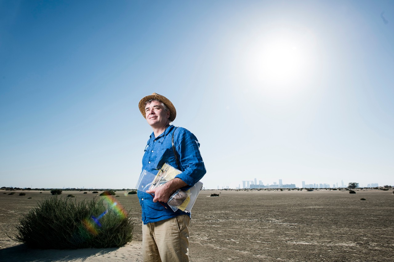 Director of the NYU Abu Dhabi Dhakira Center for Heritage Robert Parthesius stands in the desert outside Abu Dhabi.