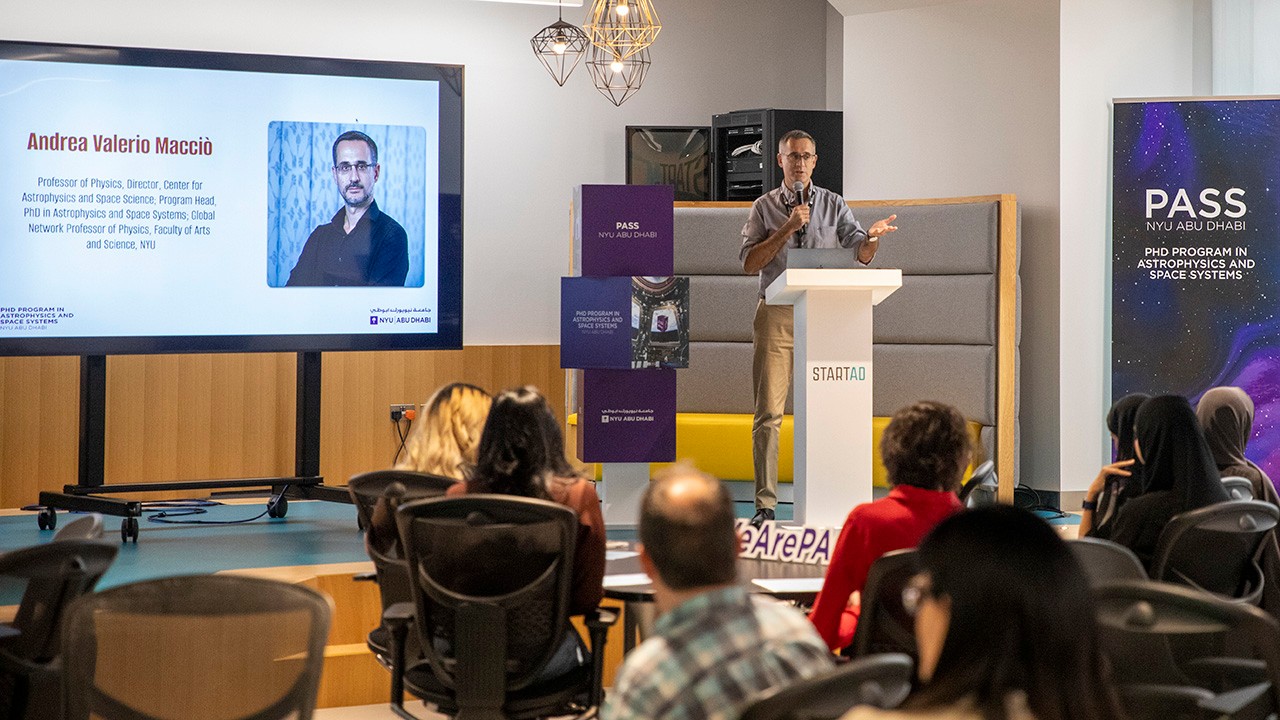 Andrea Valerio Macciò, head of NYU Abu Dhabi's PhD in Astro Physics and Space Systems, presents to a group of students.