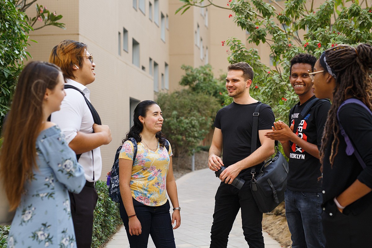 Students seen walking together on the NYUAD Saadiyat campus.