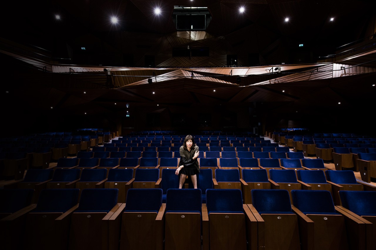 Joanna Settle, theater professor, poses in the Red Theater at the NYU Abu Dhabi Arts Center.