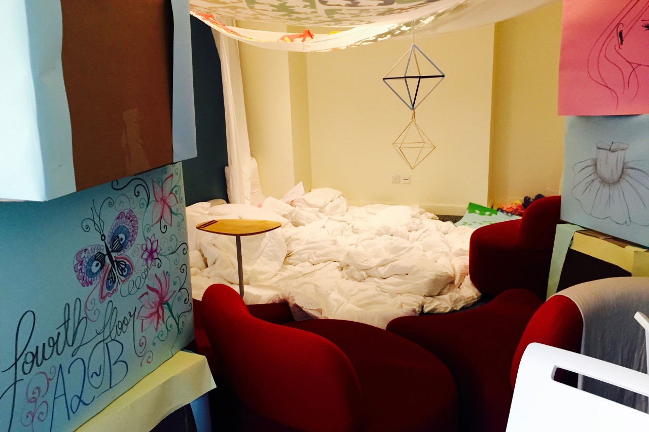 Students build a pillow fort in residence to relax and study on.