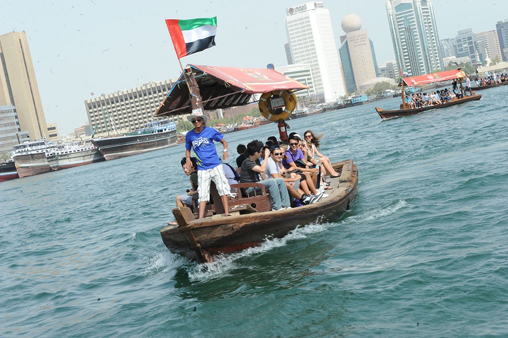 Students ride a traditional boat in Abu Dhabi.