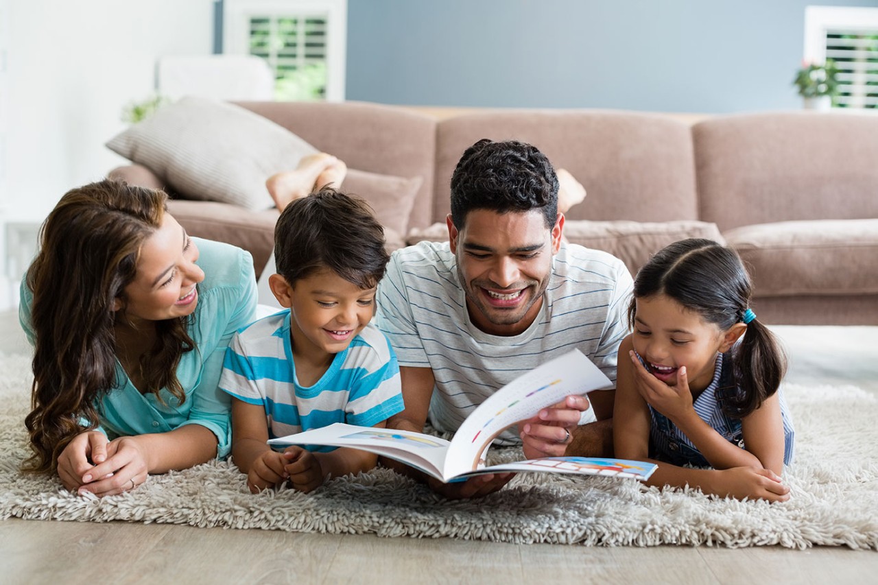A family reading together in the living room. iStock