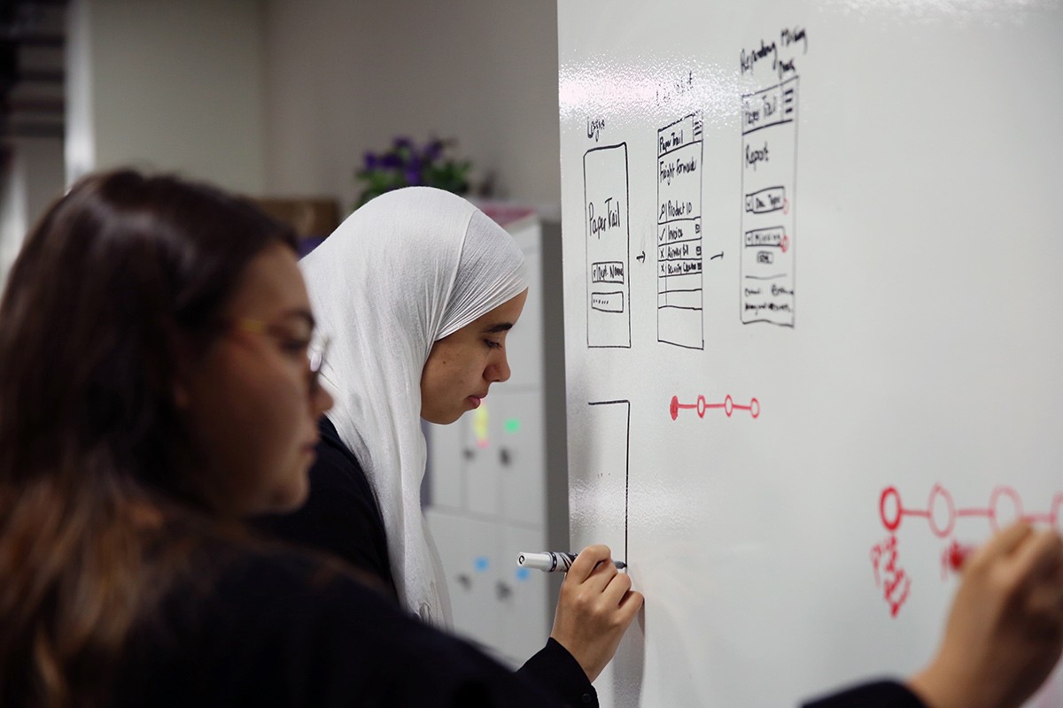 NYU Abu Dhabi sophomores Alia ElKattan and Ekin Basaran map out the strategy for their PaperTrail app.
