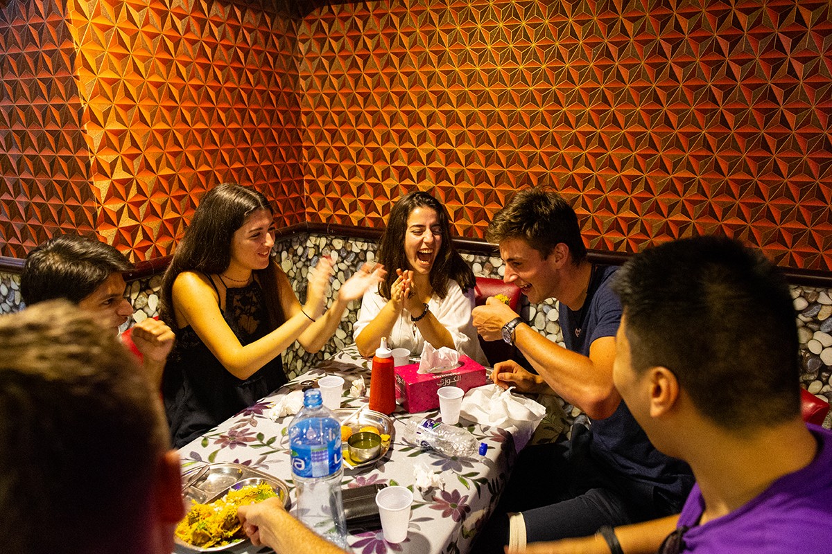NYU Abu Dhabi students enjoy a meal together at a restaurant in Abu Dhabi.
