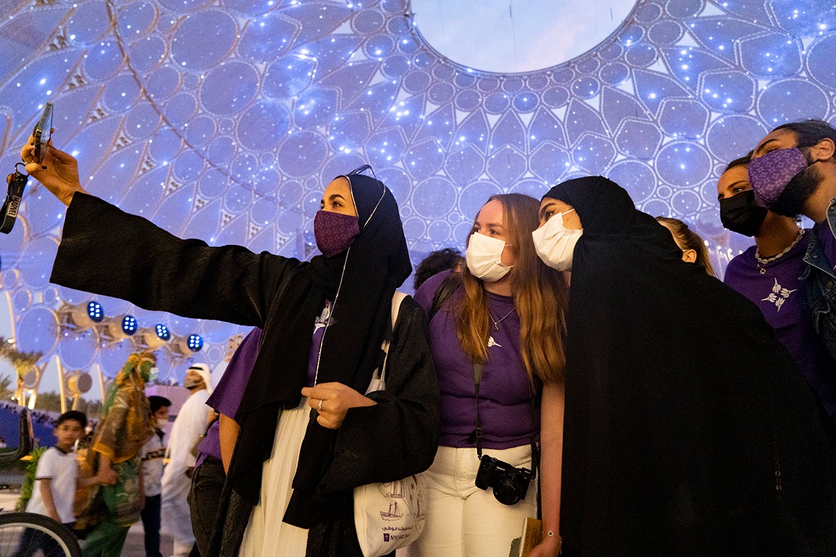 A group of NYU Abu Dhabi students taking a group photo at Expo 2020 in Dubai. 
