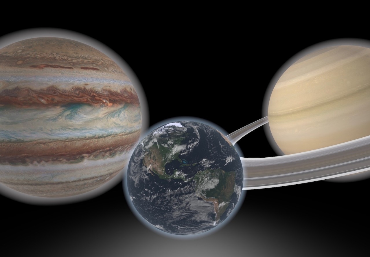 Artist concept shows a hypothetical Earth-like planet and two giant neighbors.