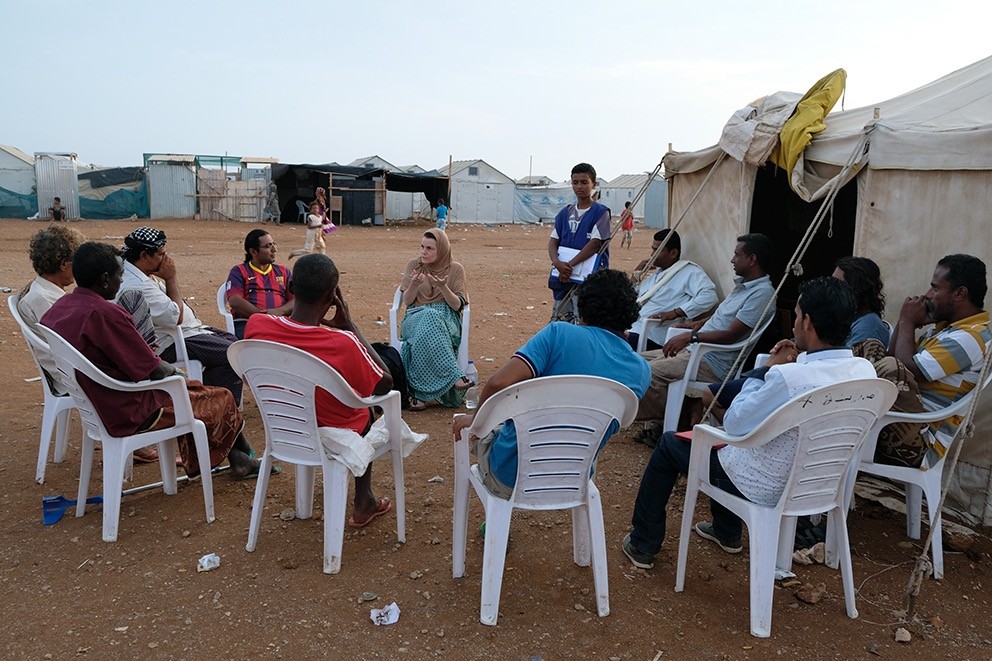 Peutz sits down with several male Yemeni refugees to talk about their experiences. Nadia Benchallal/photographer