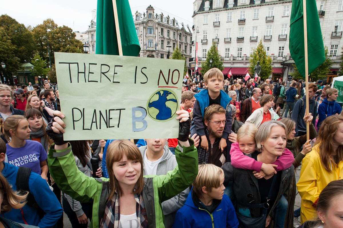 A sign reads, "There Is No Planet B", as parents carry children among thousands marching through central Oslo, Norway, to support action on global climate change. iStock