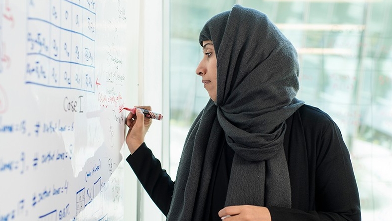 NYUAD's Hoda Al Khzaima working at the white board.