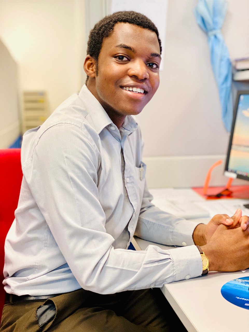 Christopher Luwanga, NYUAD Class of 2017, seated at a desk.