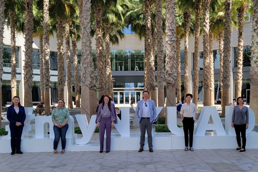 NYU Dentistry Participants in the SoTL program pose for a photo in front of the #MYNYUAD sign in Sexton Square. 