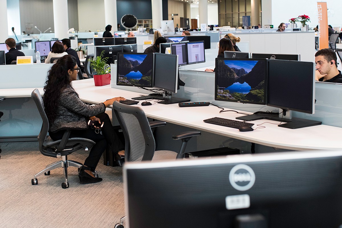 Students, faculty, and staff use workstations at the NYUAD Library.