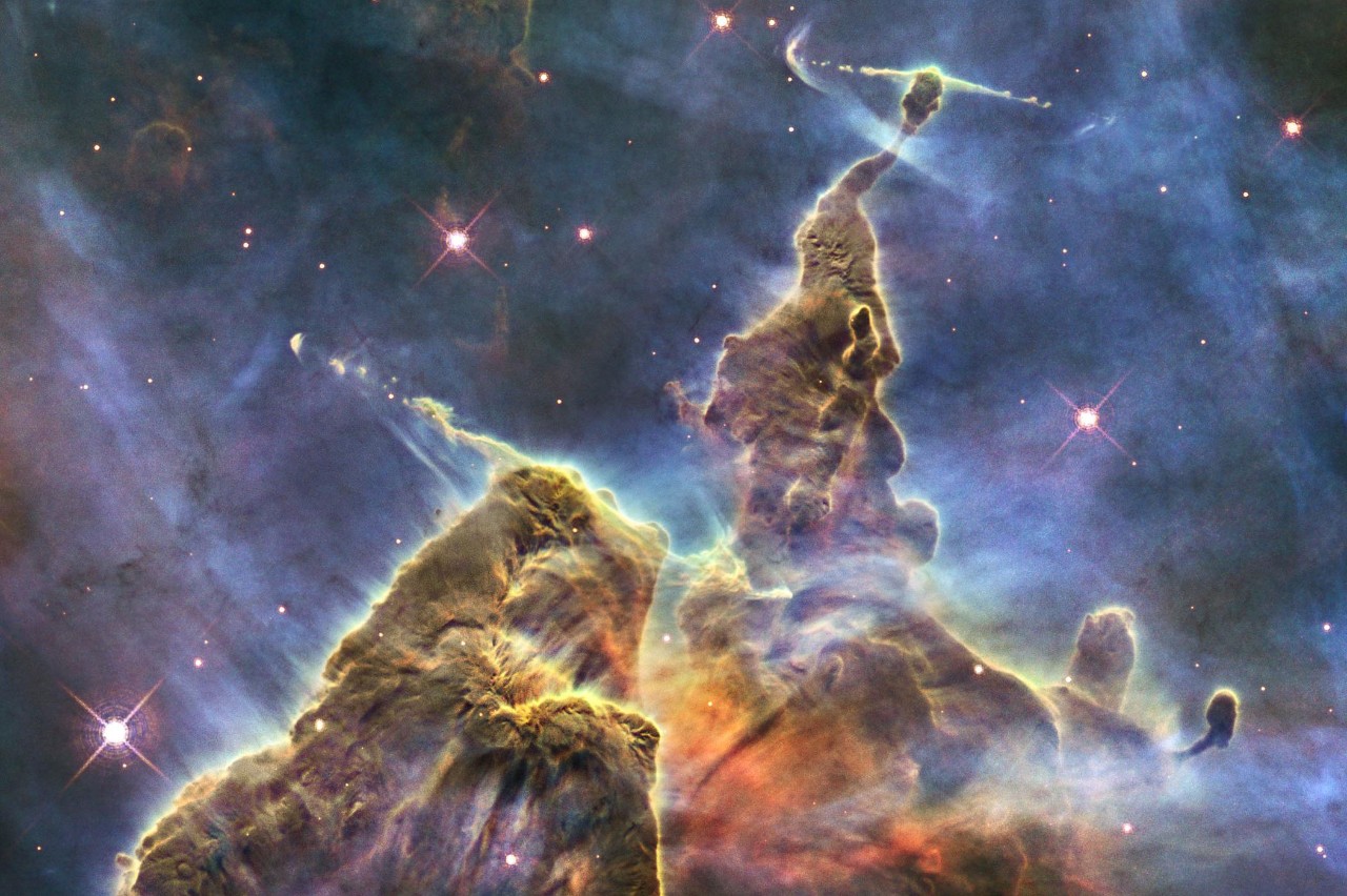 NASA's Hubble Space Telescope captures the chaotic activity atop a three-light-year-tall pillar of gas and dust that is being eaten away by the brilliant light from nearby bright stars in a tempestuous stellar nursery called the Carina Nebula.